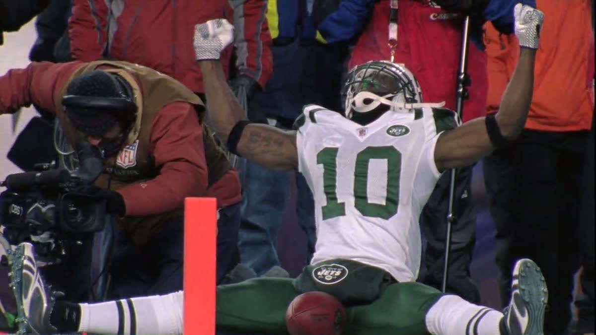 Santonio Holmes, No. 10, sitting in the end zone with his arms out after a New York Jets touchdown
