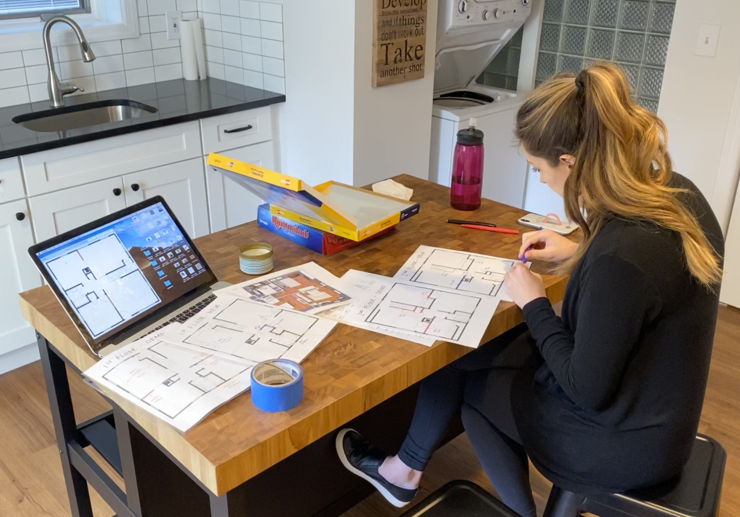 Steph at the kitchen table, drawing floorplans